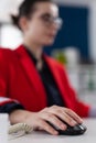 Closeup of businesswoman using wireless computer mouse in startup office Royalty Free Stock Photo