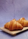 Closeup butter classic croissant on wood plate