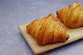 Closeup butter classic croissant on wood plate