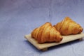 Closeup butter classic croissant on wood plate