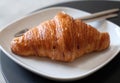 closeup butter croissant on white dish