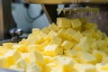 closeup of butter cubes being weighed for sale