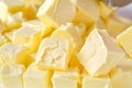 closeup of butter cubes being weighed for sale