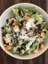 closeup of Caesar salad on a dark wood table Royalty Free Stock Photo