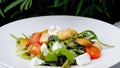 Closeup of Caesar salad plate with grilled chicken and crispy croutons on restaurant table Royalty Free Stock Photo