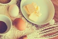 Closeup of cake cake ingredients including butter,eggs flour and cacao powder on a wooden table Royalty Free Stock Photo