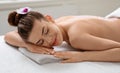 Closeup of calm young woman enjoying sea salt massage Royalty Free Stock Photo