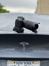 Closeup of a camera on the car trunk under the rain