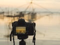 Closeup of a camera on a tripod outdoors. Background Landscape out of focus Royalty Free Stock Photo