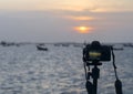 Closeup of a camera on a tripod outdoors. Background Landscape out of focus Royalty Free Stock Photo