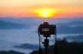 Closeup of a camera on a tripod outdoors. Royalty Free Stock Photo