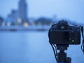 Closeup of a camera on a tripod outdoors. Background Landscape out of focus Royalty Free Stock Photo