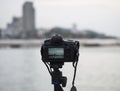 Closeup of a camera on a tripod outdoors. Background Landscape out of focus, select focus Royalty Free Stock Photo