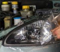 Closeup car lamp or front headlight polishing, renewed headlamp.