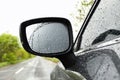 Closeup of car side rear view mirror with rain Royalty Free Stock Photo