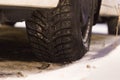 Closeup of car tires in winter on the road covered with snow Royalty Free Stock Photo