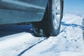 Closeup of car tires in winter on the road covered with snow Royalty Free Stock Photo