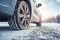 Closeup of car tires in winter on the road covered with snow