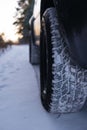 Closeup of car tires in winter on the road covered with snow. All terrain, season tire protector, for all weather conditions. M Royalty Free Stock Photo