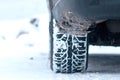 Closeup of car tires in winter on the road covered with snow Royalty Free Stock Photo