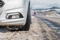 Closeup of car tires in winter on the road covered with snow. Selective focus Royalty Free Stock Photo