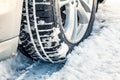 Closeup of car tires in winter on the road covered with snow. Selective focus Royalty Free Stock Photo