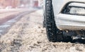 Closeup of car tires in winter on the road covered with snow. Selective focus Royalty Free Stock Photo