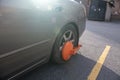 Closeup of a car with wheel clamp at a parking lot Royalty Free Stock Photo