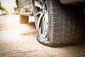 Closeup of car wheel flat tire on the road,car tire leak because of nail pounding on the street waiting for repair or changing Royalty Free Stock Photo