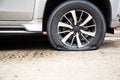 Closeup of car wheel flat tire on the road,car tire leak because of nail pounding on the street waiting for repair or changing Royalty Free Stock Photo