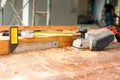 Selective focus on carpentry tools on the dirty wooden desk with sawdust