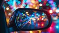 A closeup of a cars rearview mirror showcasing the kaleidoscope of lights behind it as it makes its way through the Royalty Free Stock Photo