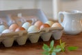 Closeup of carton of organic farm fresh eggs on rustic wood table Royalty Free Stock Photo