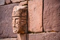 Closeup of a carved stone tenonv head embedded in wall of at the Tiwanaku UNESCO World Heritage Site near La Paz, Bolivia