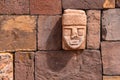 Closeup of a carved stone tenonv head embedded in wall of at the Tiwanaku UNESCO World Heritage Site near La Paz, Bolivia