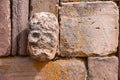 Closeup of a carved stone tenonv head embedded in wall of at the Tiwanaku UNESCO World Heritage Site near La Paz, Bolivia