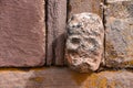 Closeup of a carved stone tenonv head embedded in wall of at the Tiwanaku UNESCO World Heritage Site near La Paz, Bolivia