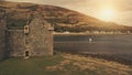 Closeup castle walls ruins at sun seascape aerial. Historic ruined palace on ocean coast