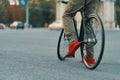 Closeup of casual man legs riding classic bike on city road