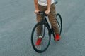 Closeup of casual man legs riding classic bike on city road