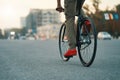 Closeup of casual man legs riding classic bike on city road