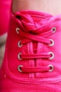 Closeup casual pink sneaker shoe boot on feet