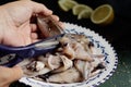 Man gutting some raw cuttlefishes