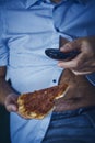 Man with a beer belly eating pizza Royalty Free Stock Photo