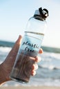 Reusable water bottle with the text plastic free