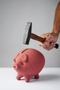 Man about to break a piggy bank with a hammer Royalty Free Stock Photo