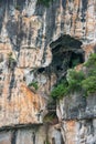 Closeup of cave opening high in cliff along Li River in Guilin, China Royalty Free Stock Photo