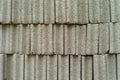 Closeup cement grey bricks out of the pile with blurred background at the construction site. Selective focus of rough white brick