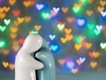 Ceramic dolls, couples are hugging together on a beautiful heart-shaped bokeh background. For valentine