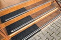 Closeup of ceramic tiles covering porch stairs with rubber anti slippery stripes on it